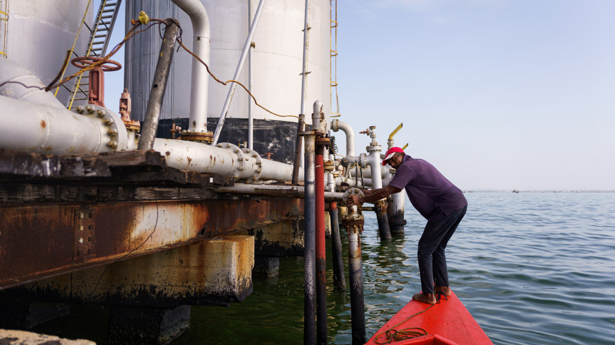 Un pescador junto a un antiguo sistema de bombeo de petróleo en Cabimas, Venezuela.